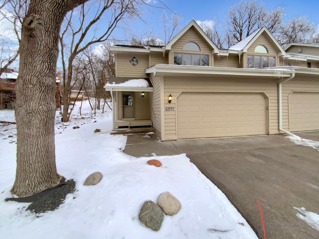 view of front of house with concrete driveway and an attached garage