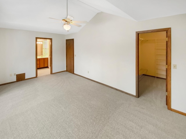 unfurnished room with vaulted ceiling, ceiling fan, light carpet, and baseboards