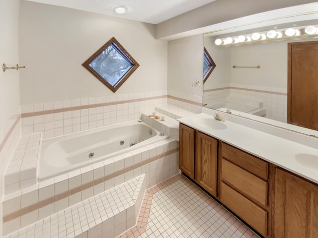 full bathroom with double vanity, a tub with jets, a sink, and tile patterned floors