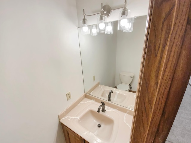 half bathroom featuring vanity and toilet