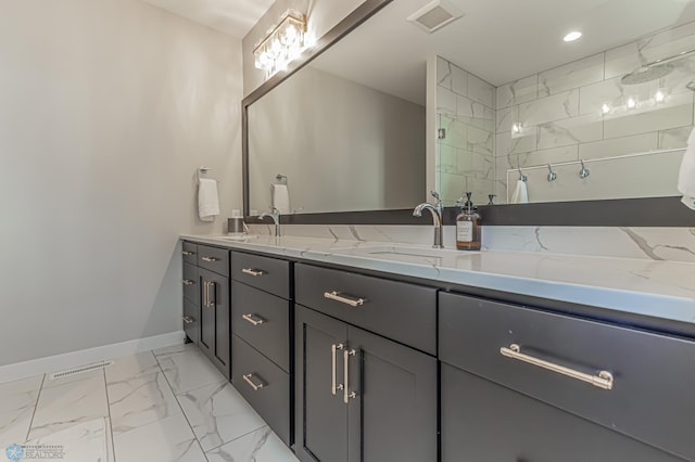 bathroom featuring marble finish floor, visible vents, a sink, and walk in shower