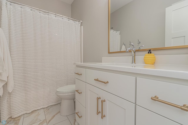 bathroom featuring marble finish floor, vanity, and toilet