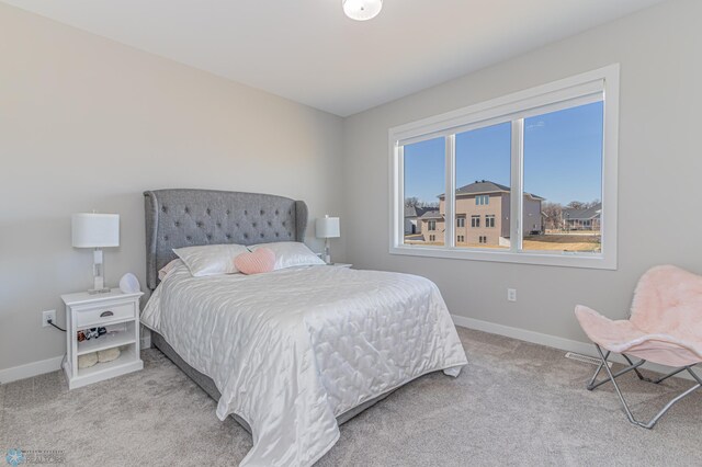 bedroom with baseboards and carpet flooring