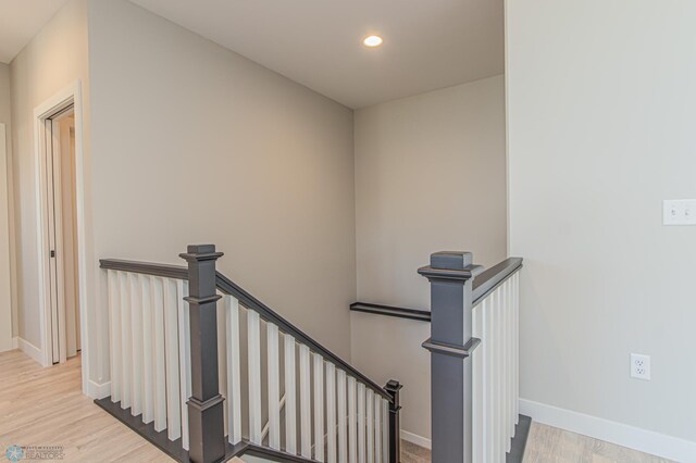 stairway with recessed lighting, baseboards, and wood finished floors