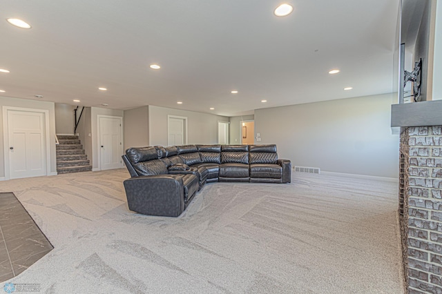 carpeted living room with baseboards, stairway, visible vents, and recessed lighting