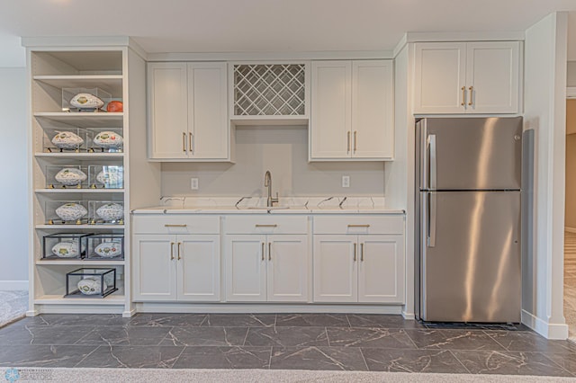 kitchen featuring white cabinetry, open shelves, light countertops, and freestanding refrigerator