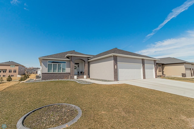prairie-style home with a garage, a front yard, roof with shingles, brick siding, and driveway