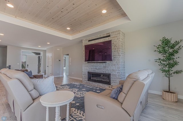 living area with light wood-style floors, recessed lighting, and wood ceiling