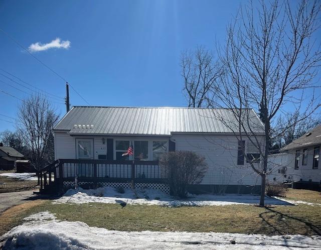 view of front of home with a porch and metal roof