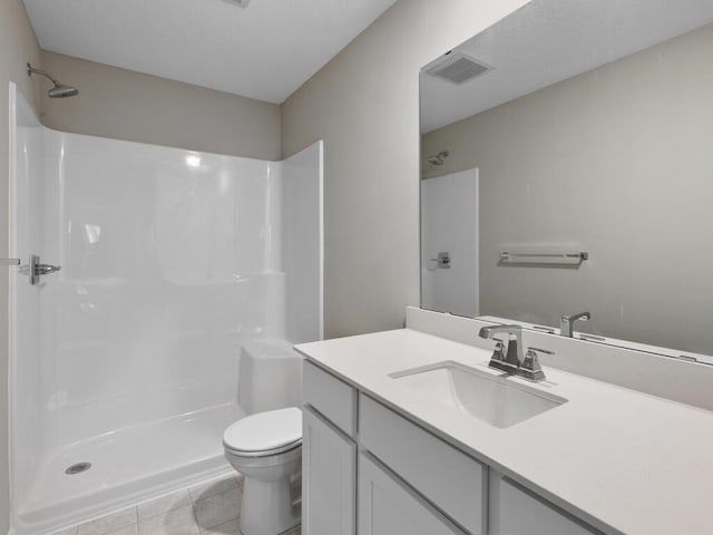 full bathroom with visible vents, toilet, tile patterned flooring, walk in shower, and vanity