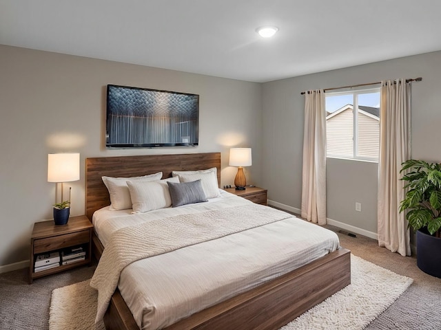 bedroom featuring carpet flooring and baseboards