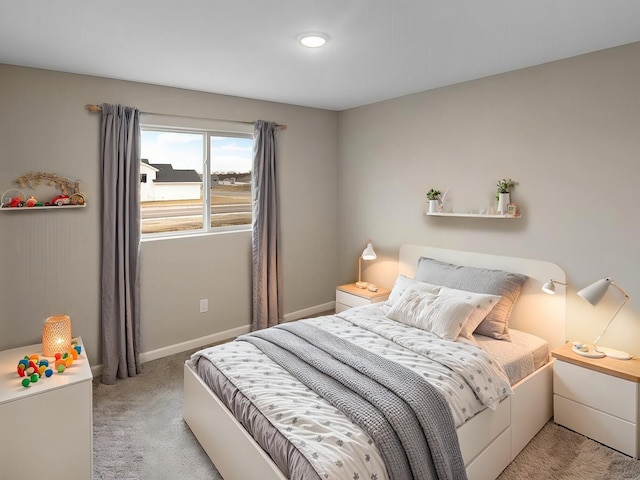 bedroom with light carpet and baseboards