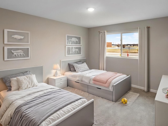 bedroom featuring carpet floors and baseboards