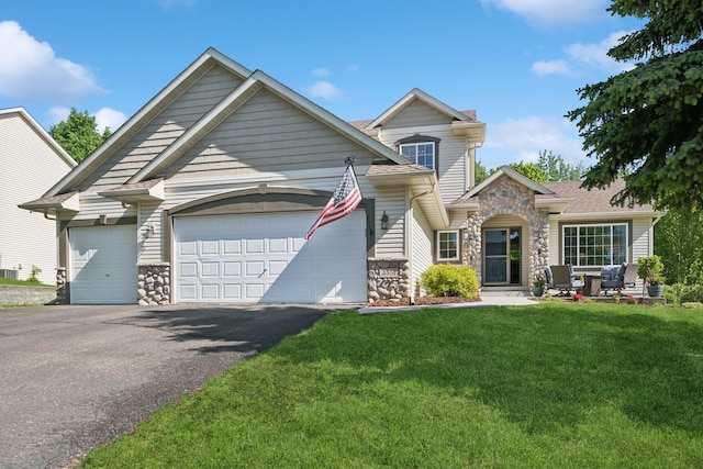 4514 Mcallister Ave NE, Saint Michael, MN 55376 - view of front facade with stone siding, a garage, a front yard, and driveway