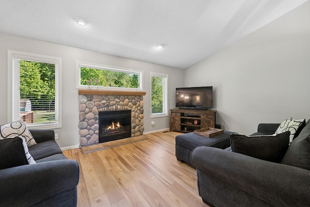 4514 Mcallister Ave NE, Saint Michael, MN 55376 - living room with a stone fireplace, lofted ceiling, wood finished floors, and baseboards
