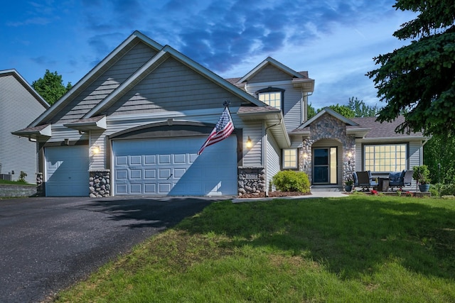 4514 Mcallister Ave NE, Saint Michael, MN 55376 - view of front of property with stone siding, a garage, a front lawn, and driveway