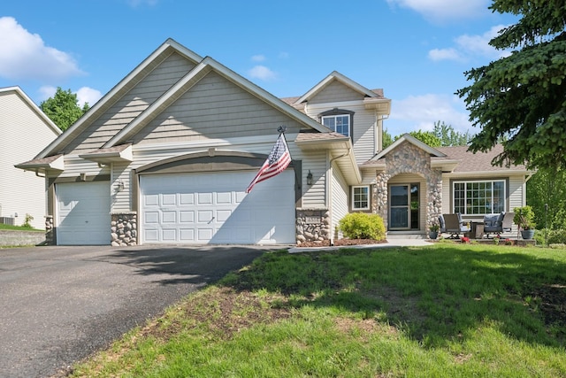4514 Mcallister Ave NE, Saint Michael, MN 55376 - view of front of house with stone siding, a garage, asphalt driveway, and a front yard