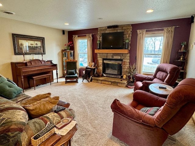 living area with a fireplace, recessed lighting, visible vents, carpet flooring, and a textured ceiling