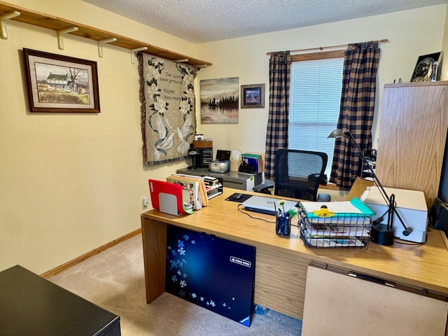 home office featuring carpet flooring, a textured ceiling, and baseboards