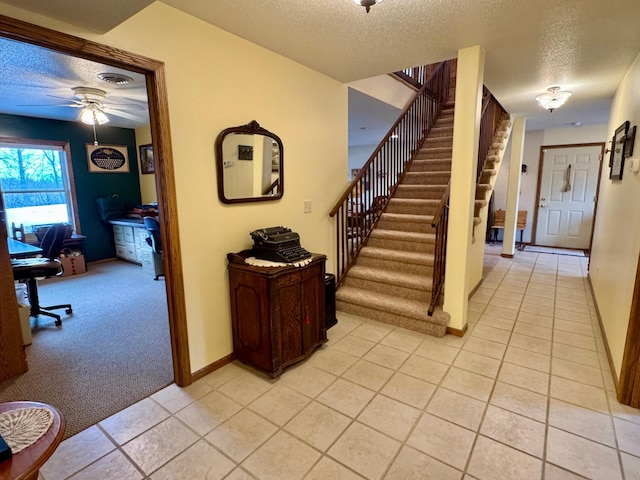 entrance foyer featuring visible vents, ceiling fan, a textured ceiling, and light tile patterned flooring