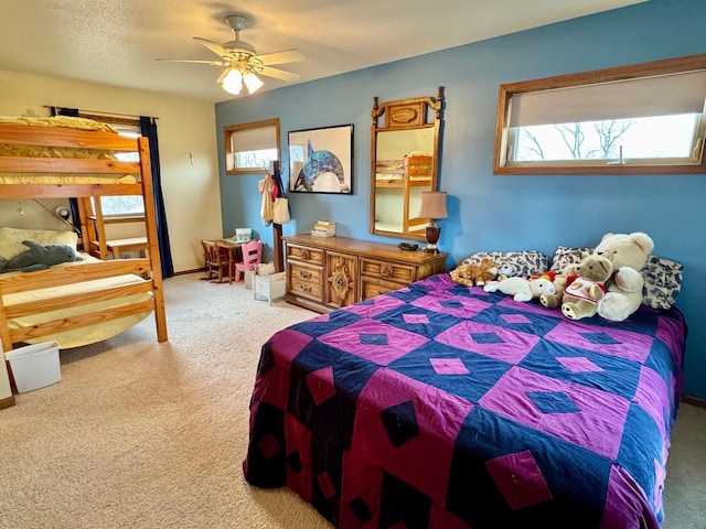 bedroom featuring a textured ceiling, carpet flooring, and a ceiling fan