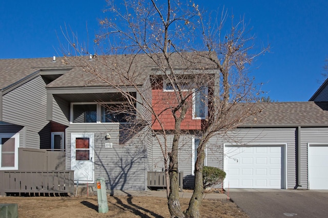 view of front of property with a shingled roof and an attached garage