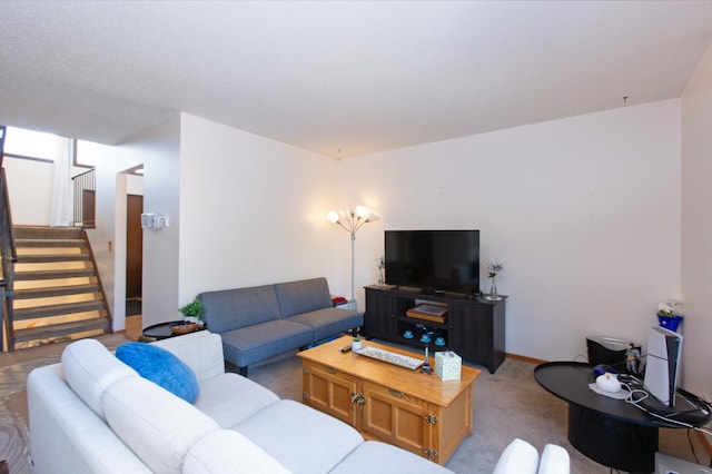 living room featuring stairway and light colored carpet