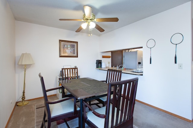 dining area featuring carpet floors, a ceiling fan, and baseboards