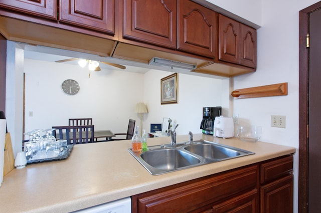 kitchen featuring ceiling fan, light countertops, and a sink