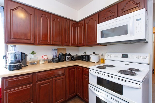 kitchen with light countertops and white appliances