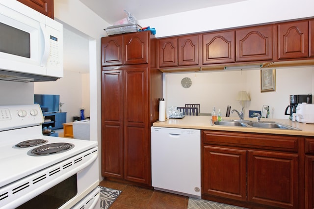 kitchen with white appliances, light countertops, and a sink