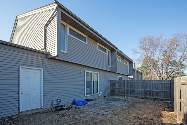 rear view of property with a fenced backyard