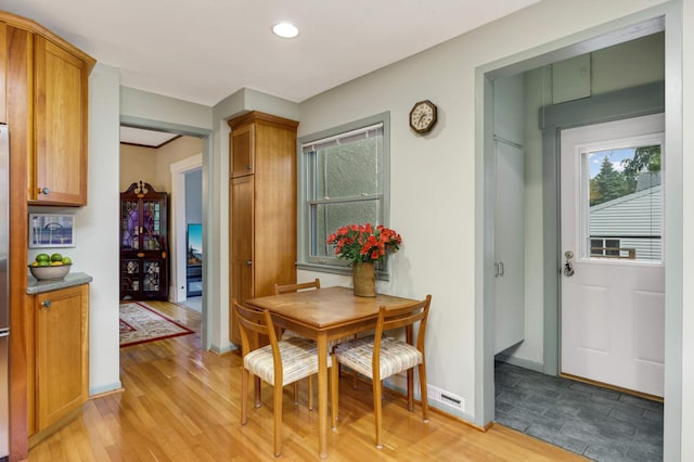 dining area with light wood finished floors, recessed lighting, and baseboards