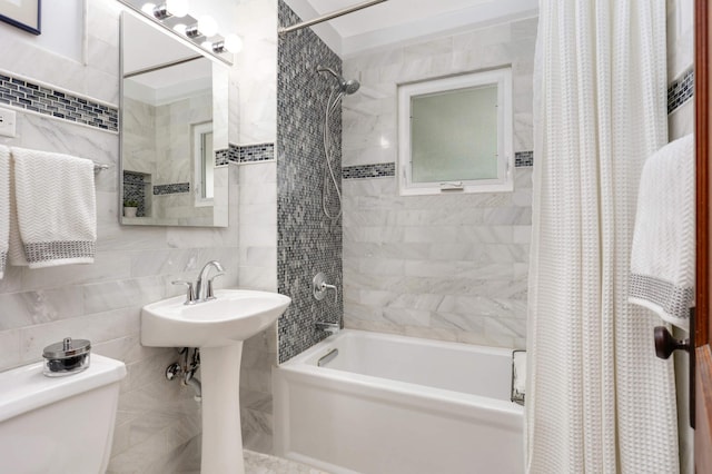 full bathroom with tile walls, tasteful backsplash, toilet, shower / bath combo with shower curtain, and a sink