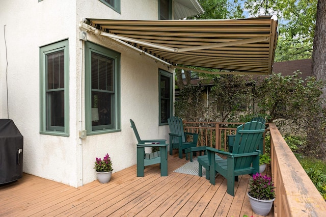 wooden terrace featuring a grill