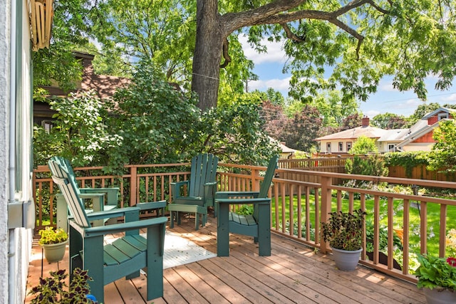 wooden terrace featuring fence