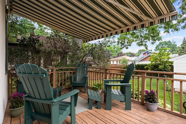 wooden terrace featuring a lawn