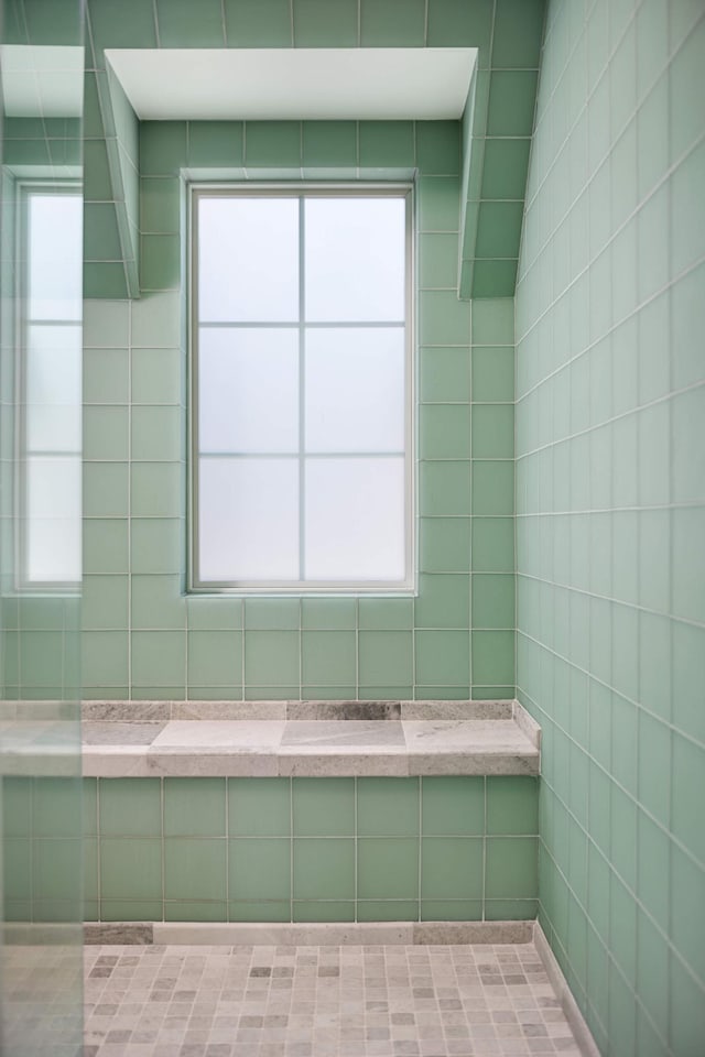 bathroom featuring a walk in shower and plenty of natural light