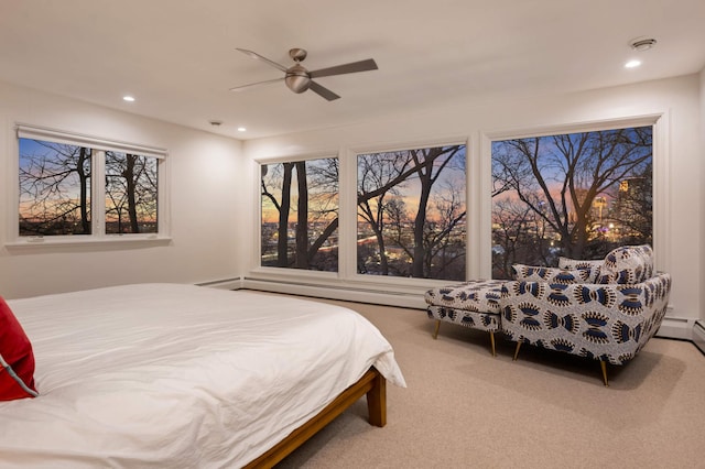 carpeted bedroom featuring ceiling fan, multiple windows, baseboard heating, and recessed lighting