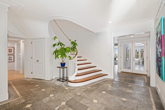 foyer entrance with arched walkways, recessed lighting, ornamental molding, french doors, and stairway