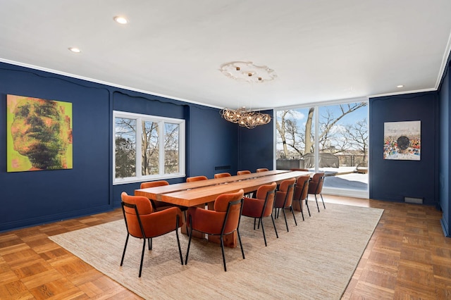 dining area with recessed lighting and an inviting chandelier