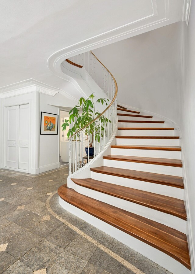 stairway featuring granite finish floor