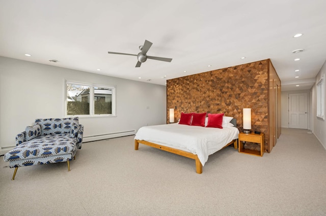 carpeted bedroom featuring an accent wall, a baseboard radiator, a ceiling fan, and recessed lighting