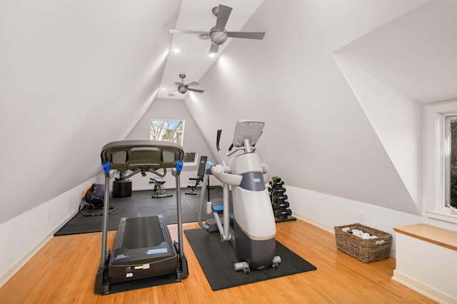 workout room with vaulted ceiling, baseboards, and wood finished floors