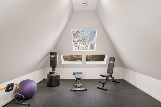 exercise area with lofted ceiling and baseboards