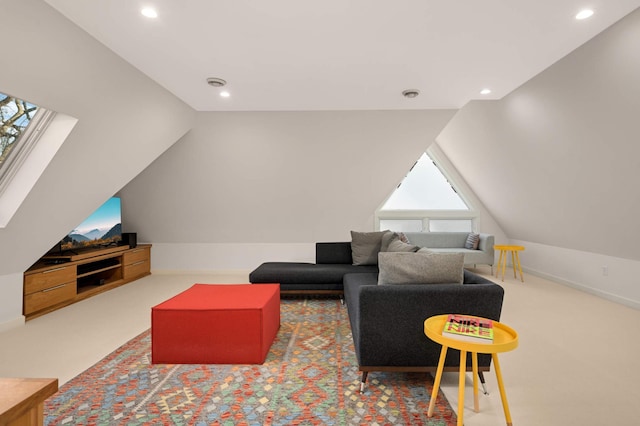 carpeted living area with lofted ceiling with skylight and recessed lighting