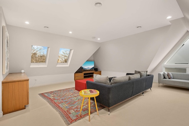 living area featuring recessed lighting, light colored carpet, and vaulted ceiling with skylight