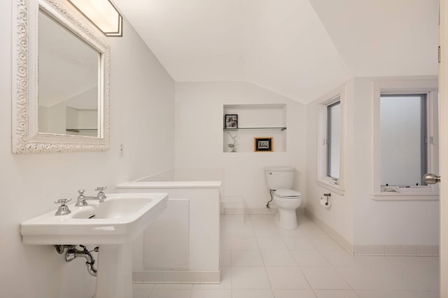 bathroom with tile patterned flooring, baseboards, vaulted ceiling, and toilet