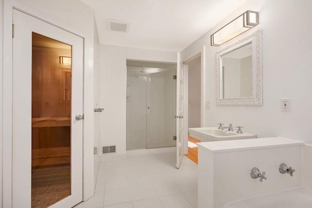 full bath featuring a stall shower, tile patterned flooring, and visible vents