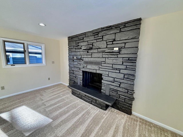 unfurnished living room with carpet, a fireplace, baseboards, and recessed lighting